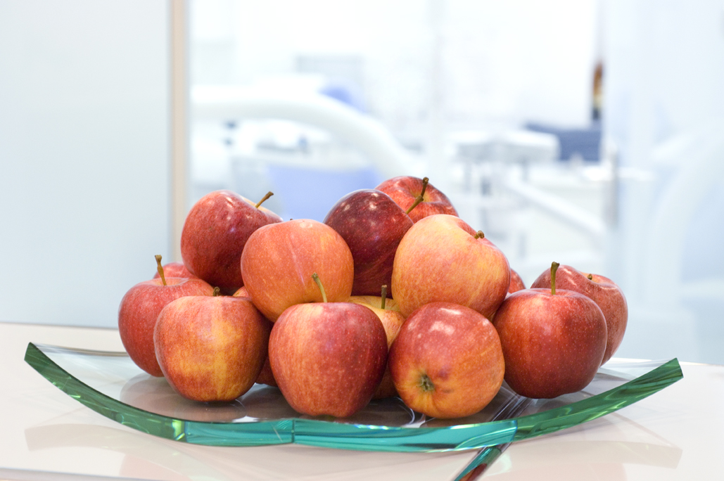 Schale mit roten Äpfeln als Symbolbild für Zahngesundheit und gesundes Zahnfleisch